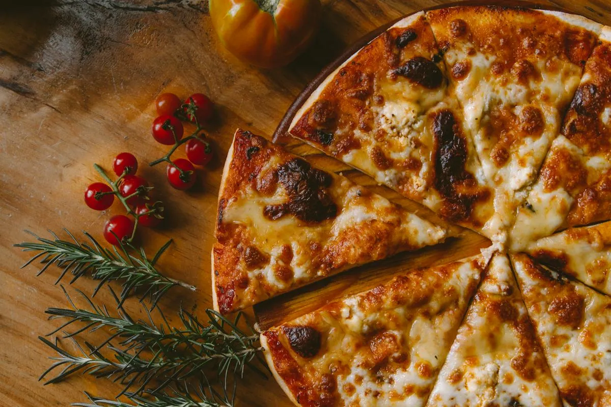 Freshly baked pizza with herbs and tomatoes