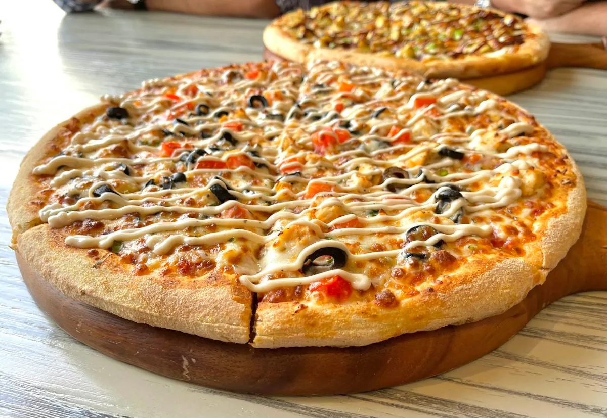 Golden baked pizza with cheese and toppings